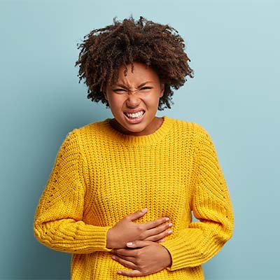 woman-holding-aching-abdomen