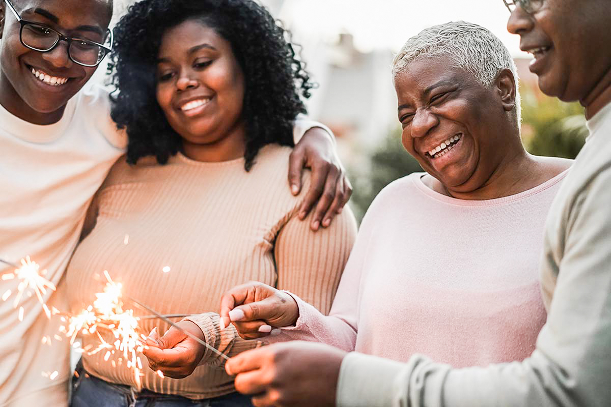 happy-black-family-celebrating-with-sparklers-outdoor-home-focus-mother-face-2