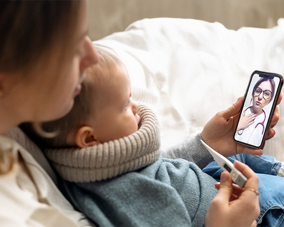 mother-with-sick-child-telehealth-care Mother with sick child doing telehealth visit